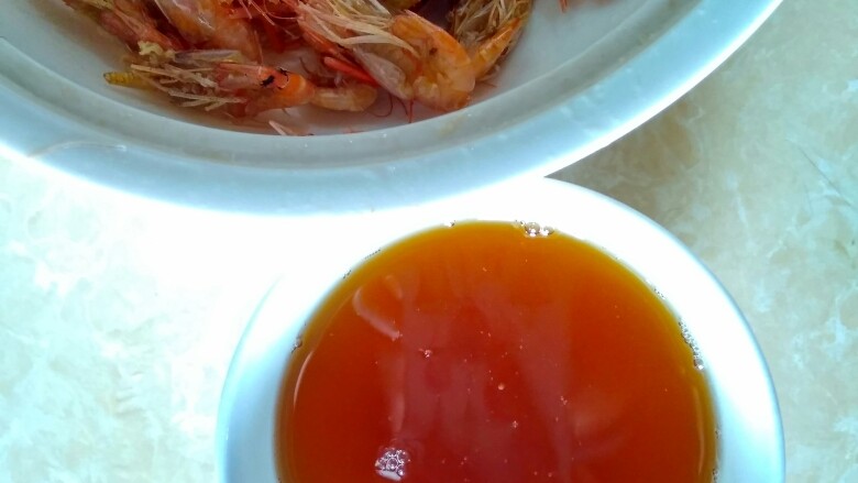 韭苔爆河虾,虾油滤干净渣滓之后盛入碗中，将锅也洗干净。