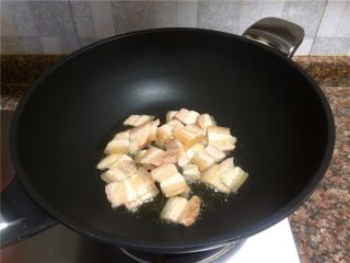 三色回锅肉,放入五花肉煸炒至肉片微卷曲出油。
