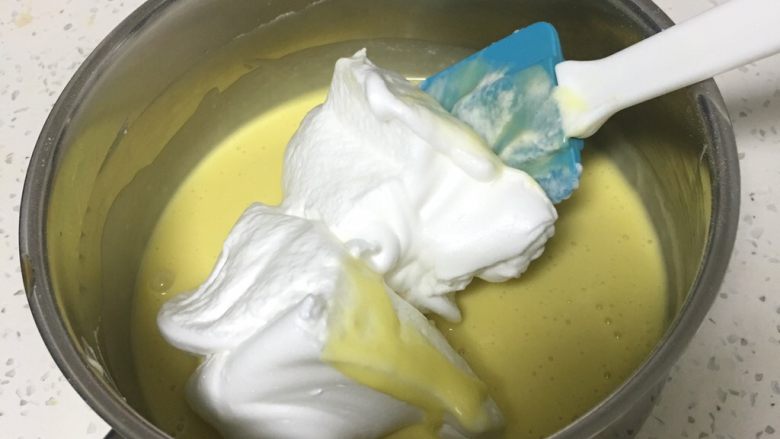 荔枝戚风蛋糕,取三分之一的蛋白进蛋黄糊中。