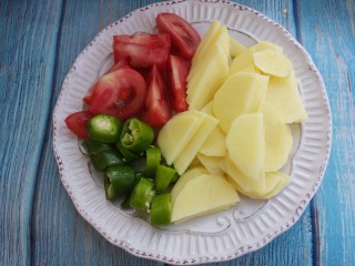 柿子炒土豆片,把土豆切成片，柿子切成块。尖椒切成椒圈。