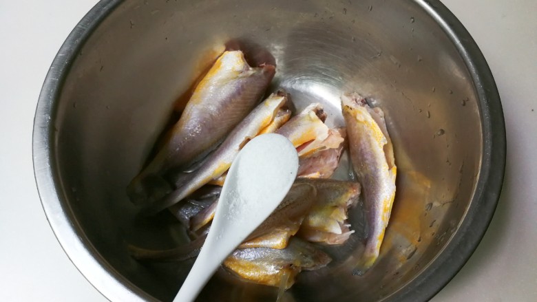 酥脆小黄鱼,黄鱼表面撒入一小勺盐