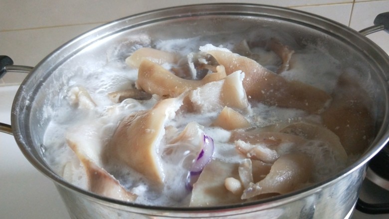 新文美食  美容养颜猪皮冻,猪皮用开水煮10钟后捞出来。