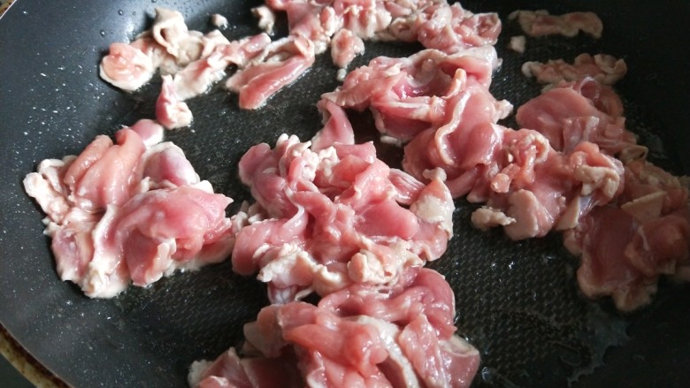 新文美食  葱爆猪肉片,先用不沾锅烧热倒入适量油，倒入肉片。