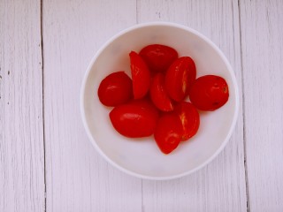 小番茄培根意面,把小番茄洗干净，切成两半。