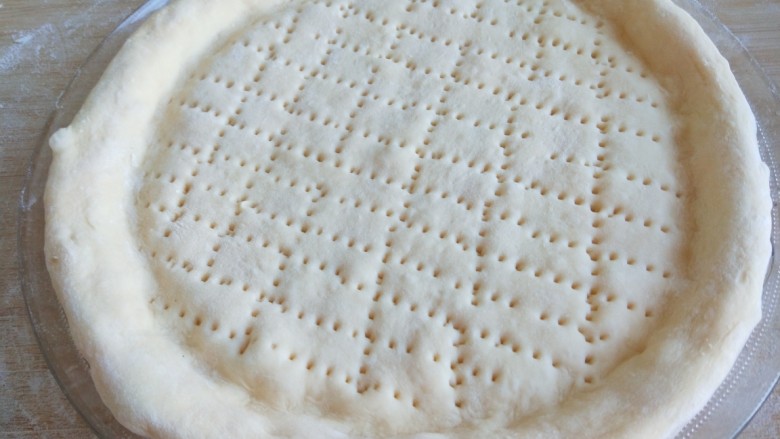 新文美食  自制披萨饼,在用钢叉扎出均匀的印子。