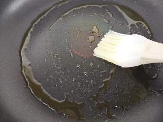 火腿肠鸡蛋饼,然后用刷子把锅里刷上油。