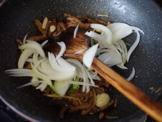 鳝鱼炒菜脯,放入洋葱丝和蒜苗头一起翻炒至洋葱出香味变软