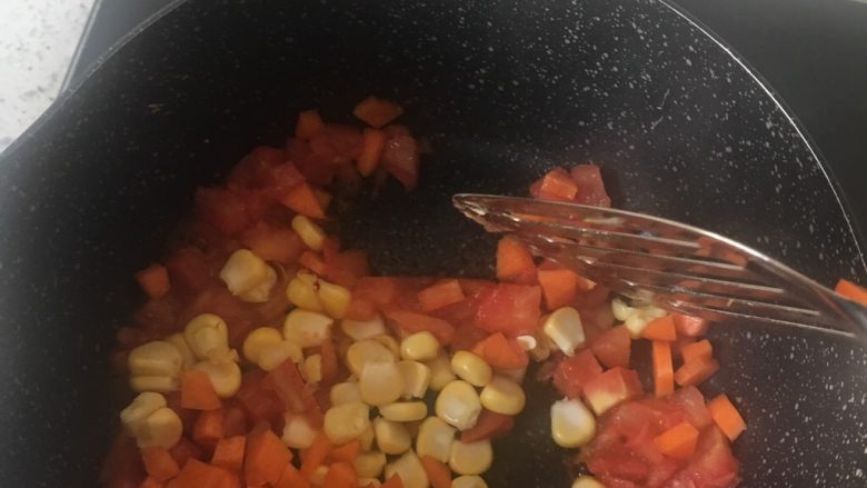 杂蔬蛋炒饭,5️⃣ 倒入胡萝卜丁和玉米粒翻炒2 3分钟至玉米粒通透。