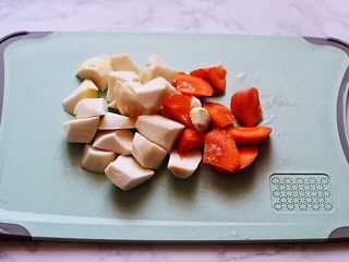 十味  超美味的咖喱芋头鸡肉饭,把洗净的芋头和胡萝卜用刀切成滚刀块备用。