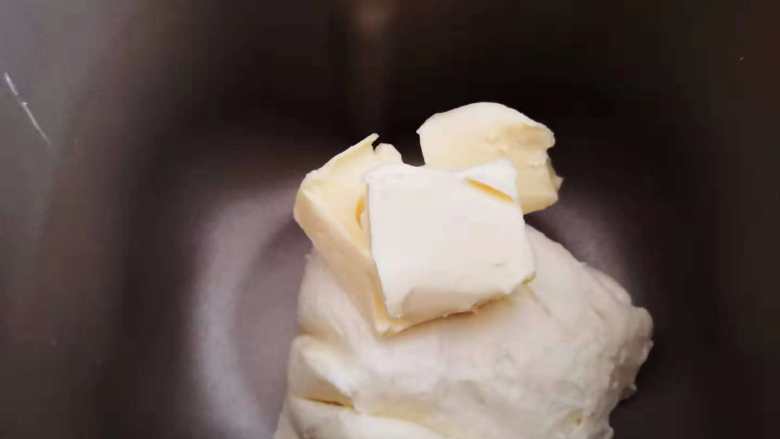 麻薯-恐龙蛋,待面团混合均匀细腻后加入软化好的黄油，继续搅拌。
