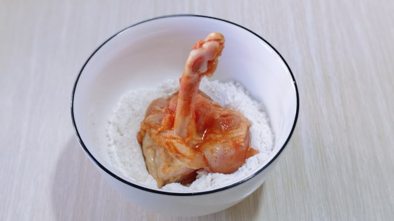沙茶鸡翅锤,首先将腌制好的鸡锤放入淀粉碗中，均匀裹上淀粉！