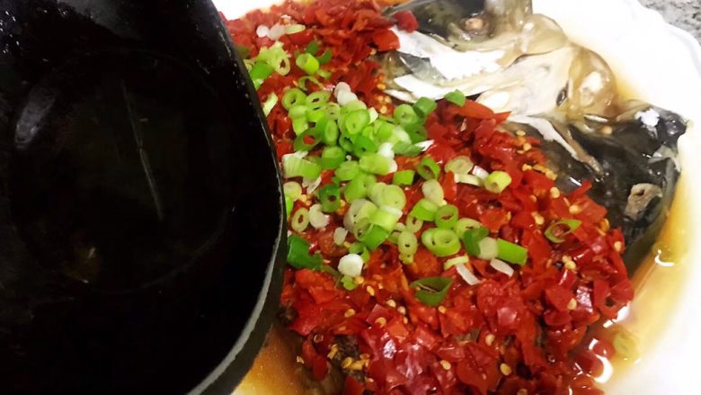 剁椒鱼头,剁椒上面撒上葱花热花椒油趁热浇在上面