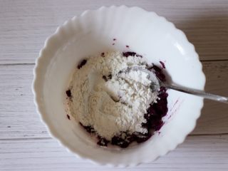 双色水晶豆沙汤圆,紫薯泥也趁热取出先加入5克白糖和5克炼乳后用勺子搅拌均匀后，分次加入60克糯米粉。