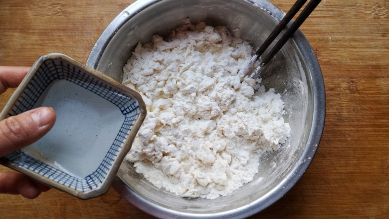翡翠饺子——用一盘情意绵绵的饺子温暖整个冬天,在面粉中加入适量的水（少量多次加入），并用筷子搅拌成雪花状。