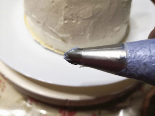 漂亮的芭比蛋糕,用碗取适量的淡奶油，加入紫色素，用刮刀拌匀，装入裱花袋，裱花袋里放上叶子裱花嘴，用来挤裙摆，
