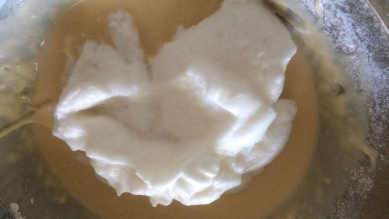 萌萌哒小熊松饼,将1/2的蛋白霜加入至蛋黄糊中，翻拌均匀；