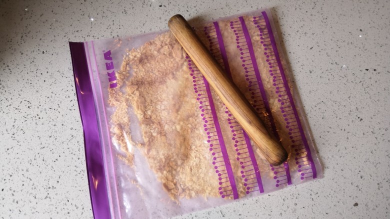 重芝士蛋糕,将消化饼干装入密封袋里用擀面杖压碎。