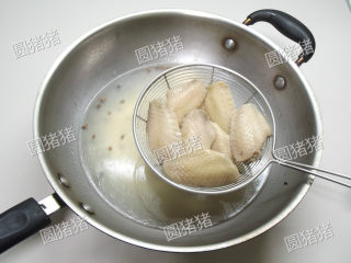 红烧鸡翅,锅内放入水、料酒、花椒煮开，放入鸡翅氽烫至水再开捞起。