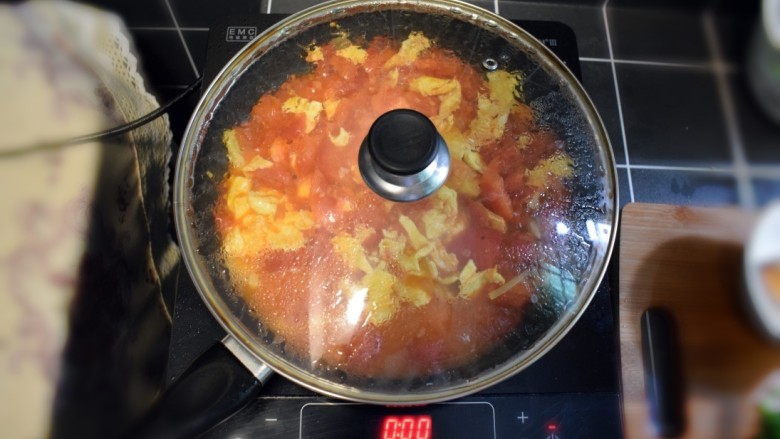 西兰花番茄炒鸡蛋盖浇饭,翻炒几下后，加入半碗清水，盖上锅盖，焖煮一会儿。