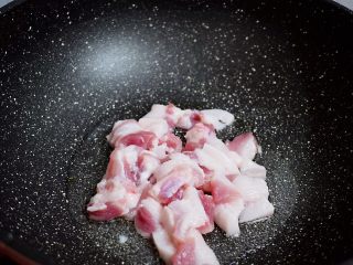 干煸菜花,锅中倒入适量的食用油烧热，放入猪肉翻炒至变色变白