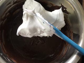 6寸巧克力戚风,将三分之一蛋白加入蛋黄糊并翻拌均匀