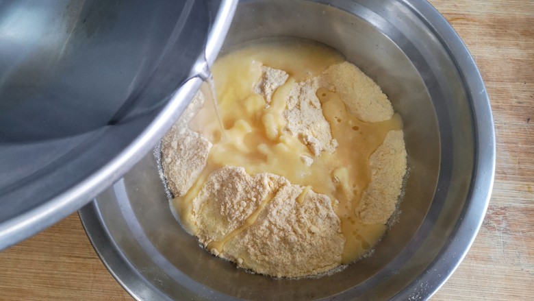 鱼锅片片,在玉米面中加入适量的开水（少量多次加入）。