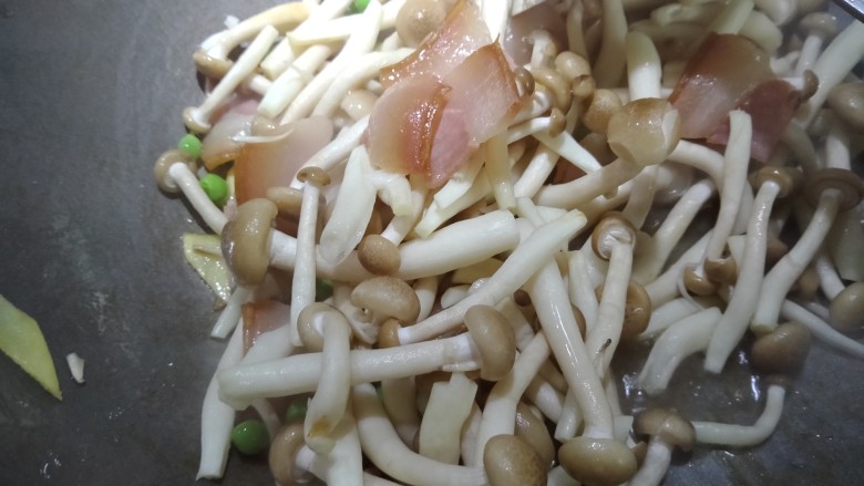 火腿蟹味菇,再放入豌豆米，蟹味菇，中火慢慢滑炒，最后小火慢慢炒，等汤汁变稠。