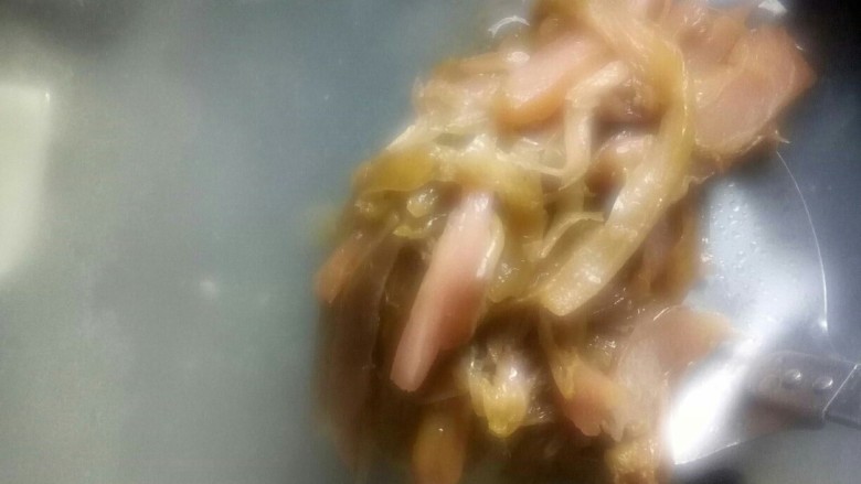 酸香风味鱼头锅,烧沸后加入炒香的酸青菜丝继续熬制。
