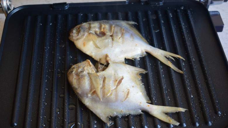 自制烤鱼,牛排机预热，刷一层食用油，加入腌制好的鱼，盖上上盖