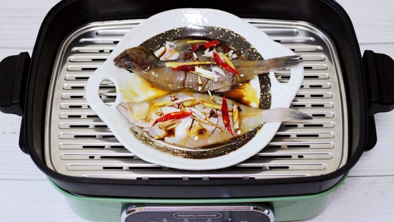 补脑养生的清蒸比目鱼,美食锅里倒入适量清水烧开后，把腌制好的比目鱼放入锅中。
