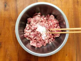 梅花蒸饺,醒面团的过程中，来调制饺子馅。首先在肉馅里加入盐，使劲朝一个方向搅拌，直至搅拌至肉上劲。