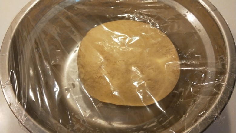 新文美食  南瓜红糖发面饼,合好的面团封上保鲜膜。