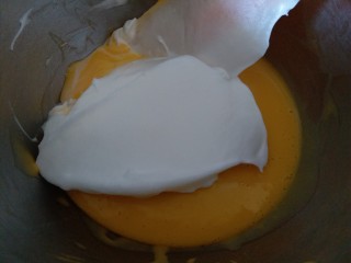 圣诞杯子蛋糕,分三分之一的蛋白霜到蛋黄糊内，用刮到翻拌切拌均匀。