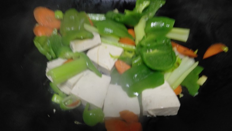 清炒豆腐菜椒,不粘锅中放入适量油，倒入上述食材。