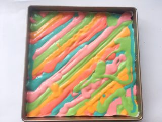 彩虹蛋糕
,烤盘挤满一层后，将剩下的面糊挤在表层，蛋糕糊表面厚度均匀即可
