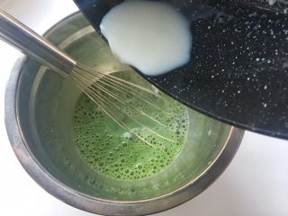 抹茶毛巾卷（抹茶奶黄酱）,将热牛奶一点点倒入抹茶糊中，之后用蛋抽搅拌均匀
