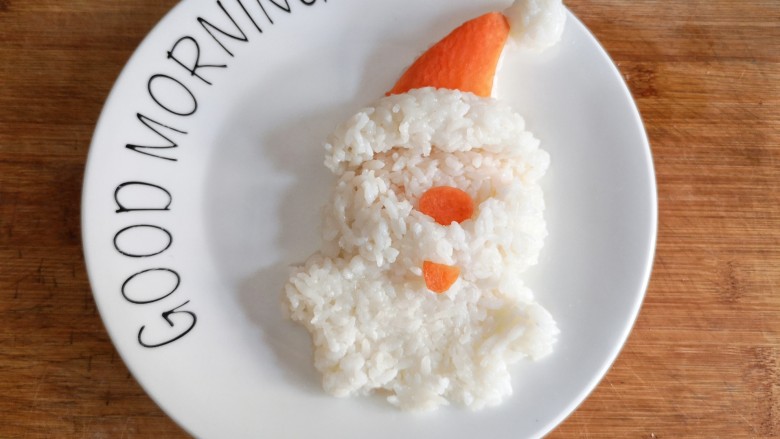 圣诞咖喱鸡饭,将胡萝卜切薄片，剪成帽子，鼻子，嘴的形状，摆在适当的位置。