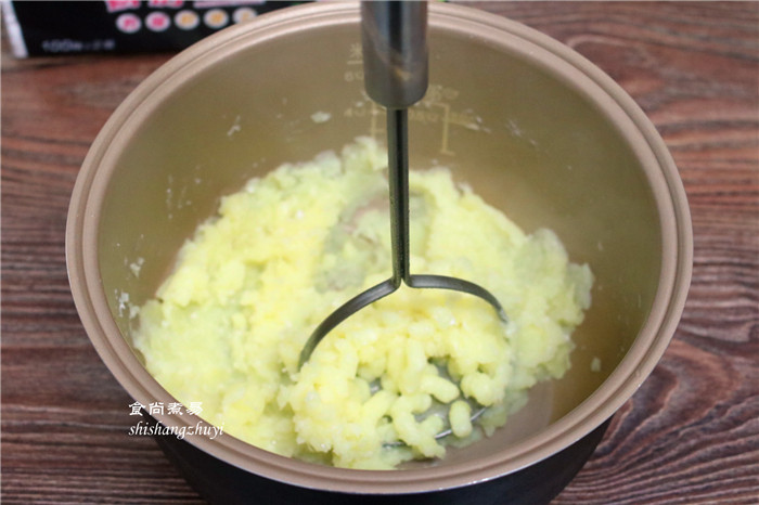 凤尾虾球,土豆片倒入高脚盆里，调入2克盐、用压泥器把土豆压烂，没有压泥器就直接用叉子或用手捻碎。