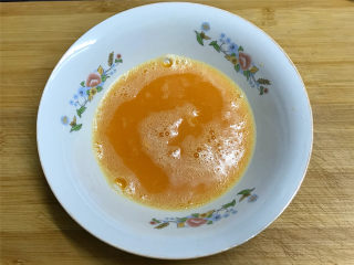 西红柿炒鸡蛋,打入碗中的鸡蛋加入适量料酒和少许盐，用筷子打散。
