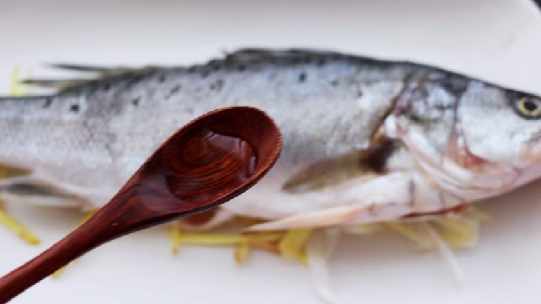 鲜美无比的粤式清蒸鲈鱼,这个时候在鱼身上浇上<a style='color:red;display:inline-block;' href='/shicai/ 718'>料酒</a>来去除鱼的腥味。