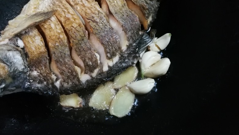 白酒香菜鳊鱼,放入蒜瓣姜片
