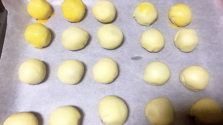传统中式点心蛋黄酥,鸡蛋黄蛋液打散，用油扫把蛋液均匀扫一层到蛋黄酥表面