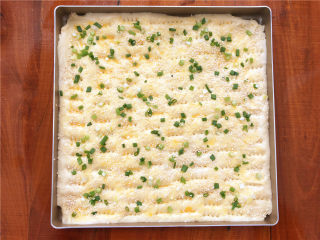 香葱肉松面包卷,刷上一层蛋液（揉面团用剩下的蛋液），撒上芝麻和香葱。
