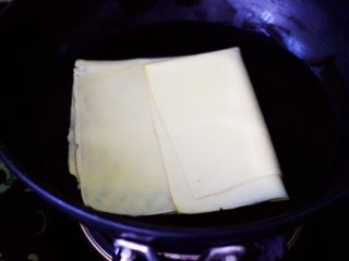 经典不衰的京酱肉丝,锅中倒入适量的清水煮沸，加入少许盐后把豆腐皮放入锅中焯水，煮一分钟左右，看见豆腐片变软即可。