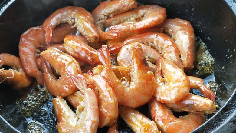 年夜饭之油焖大虾,煎至两面金黄，煎的时候不断的按压虾头，使虾油释放出来。