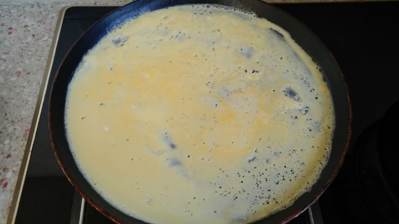 东北大拉皮,倒入不粘锅 摊成鸡蛋饼 鸡蛋饼定型后 翻面 关火 利用锅的余温把鸡蛋饼带熟 这样摊出来的鸡蛋饼才嫩。
