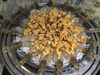 金蒜粉丝蒸虾,将蒜末均匀的铺在虾上，倒入生抽，料酒，放入蒸锅，水开后蒸8分钟左右