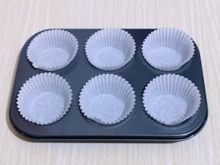 新手入门级～蓝莓椰蓉马芬蛋糕,准备好6个纸托，将纸托放入模具中，如图。