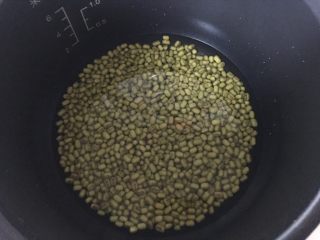 红枣绿豆养生粥,绿豆连同泡过的水加入电饭煲内