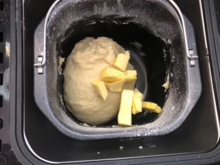 椰蓉小餐包,20分钟以后加入室温软化的黄油，继续揉面40分钟。